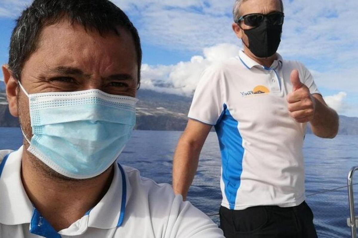 a man wearing a face mask and a man giving a thumbs up