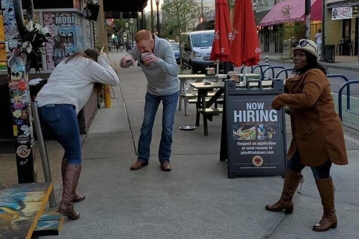 a couple of people standing on a sidewalk