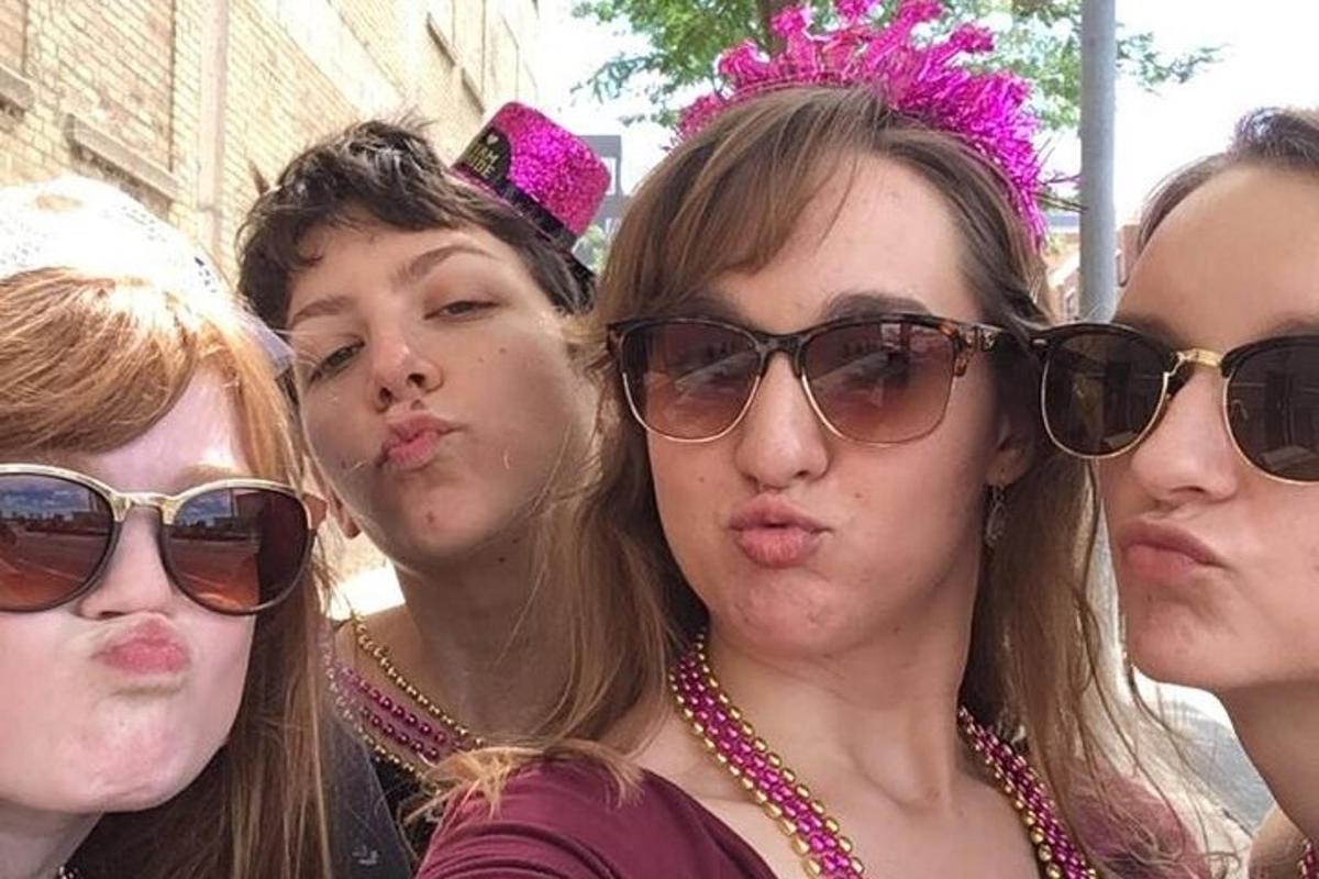 a group of women wearing sunglasses and pink bow ties