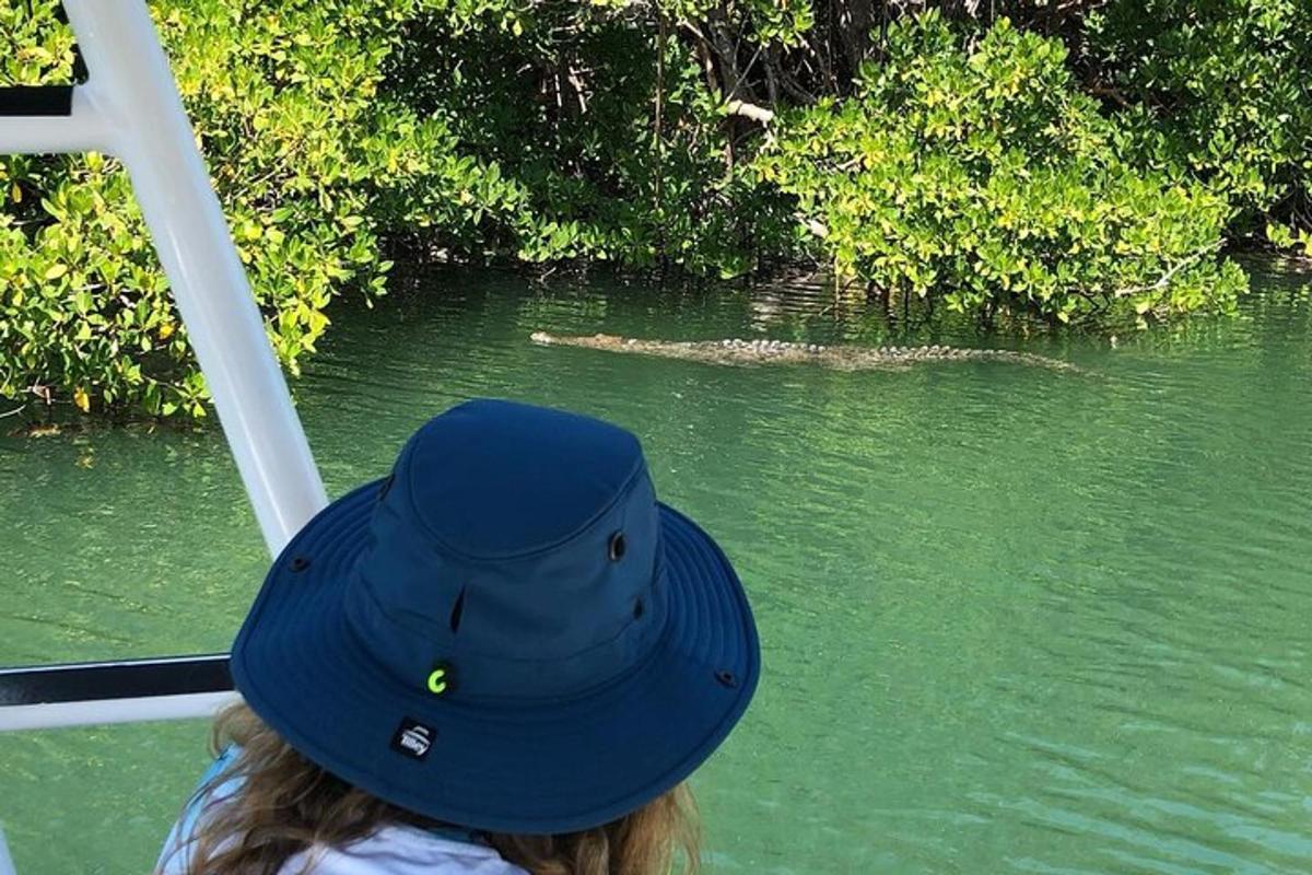 a person wearing a blue hat on a boat in the water