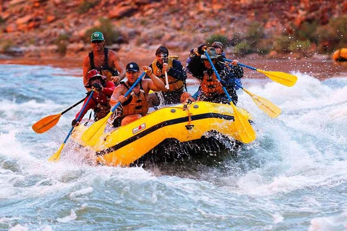 a group of people in a yellow raft in the water