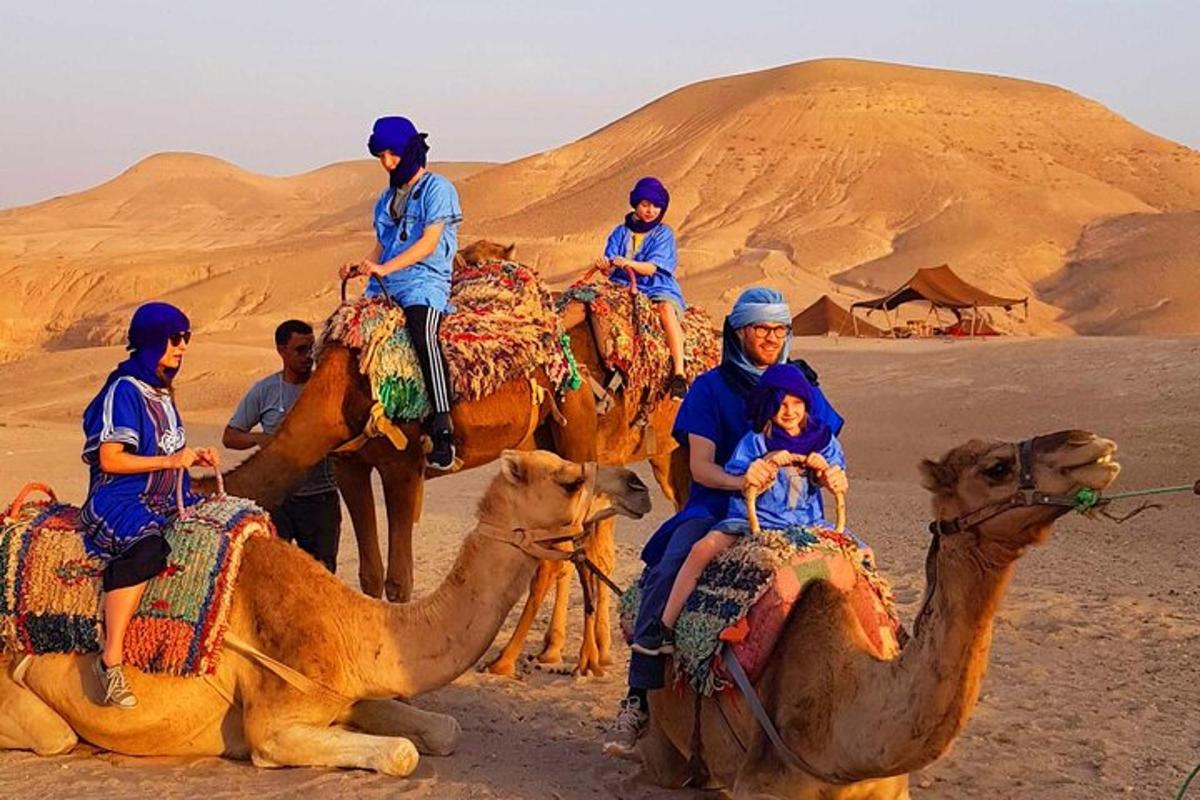 a group of people riding on camels in the desert