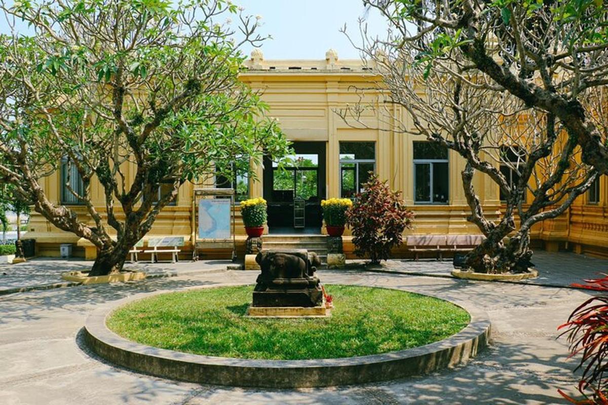 a statue in front of a building with trees