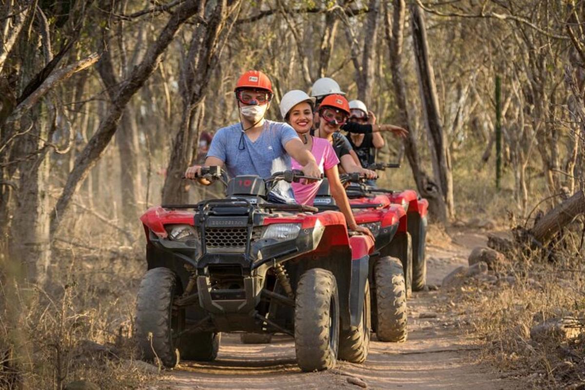 a group of people riding on atvs on a trail