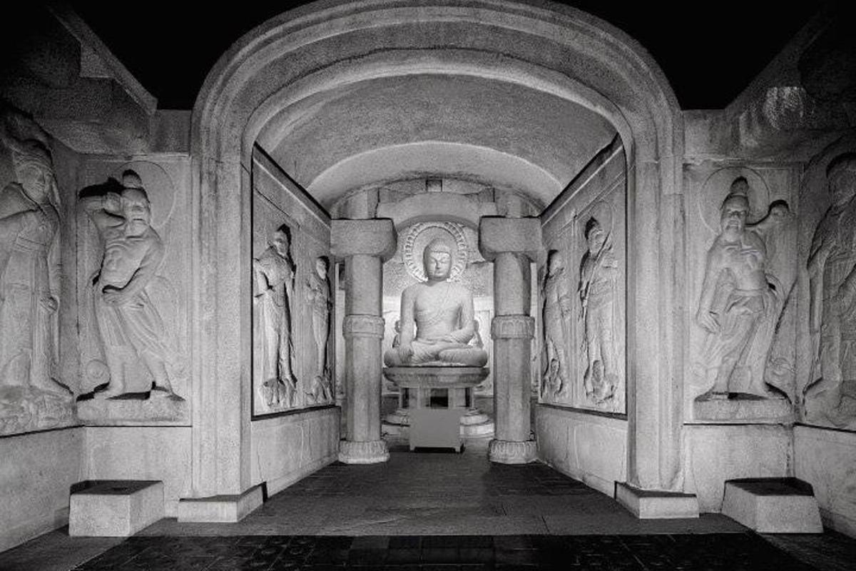 a room with statues on the walls of a building
