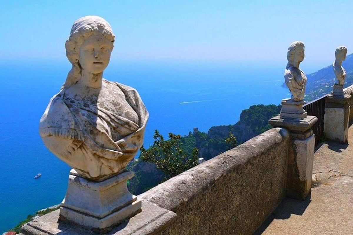 ένα άγαλμα μιας γυναίκας σε έναν τοίχο με θέα στον ωκεανό
