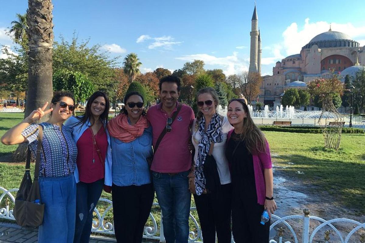 a group of people posing for a picture in front of a mosque
