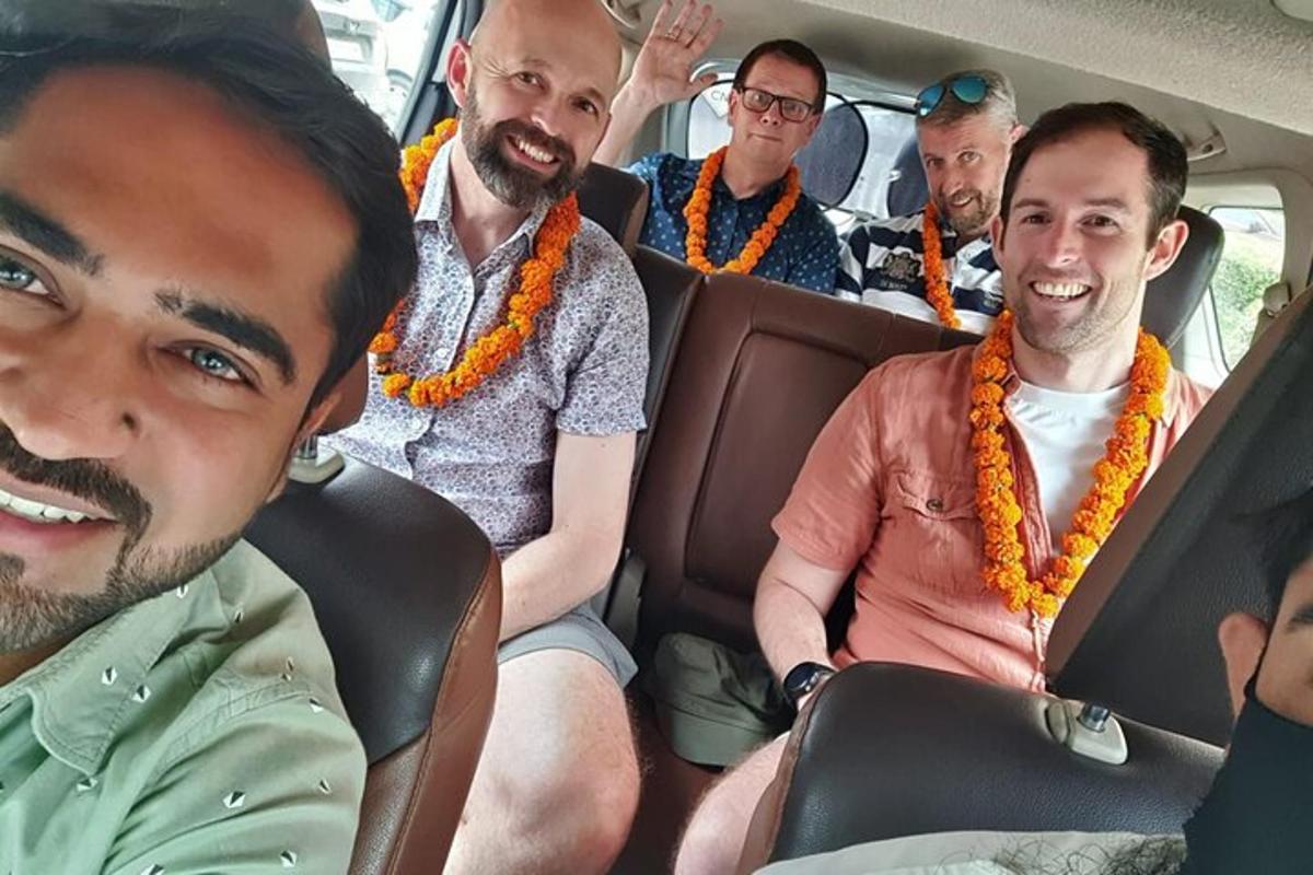 a group of men sitting in a car