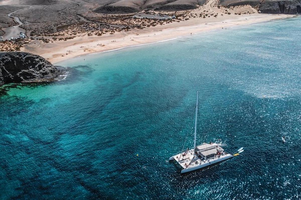 a boat in the water next to a beach