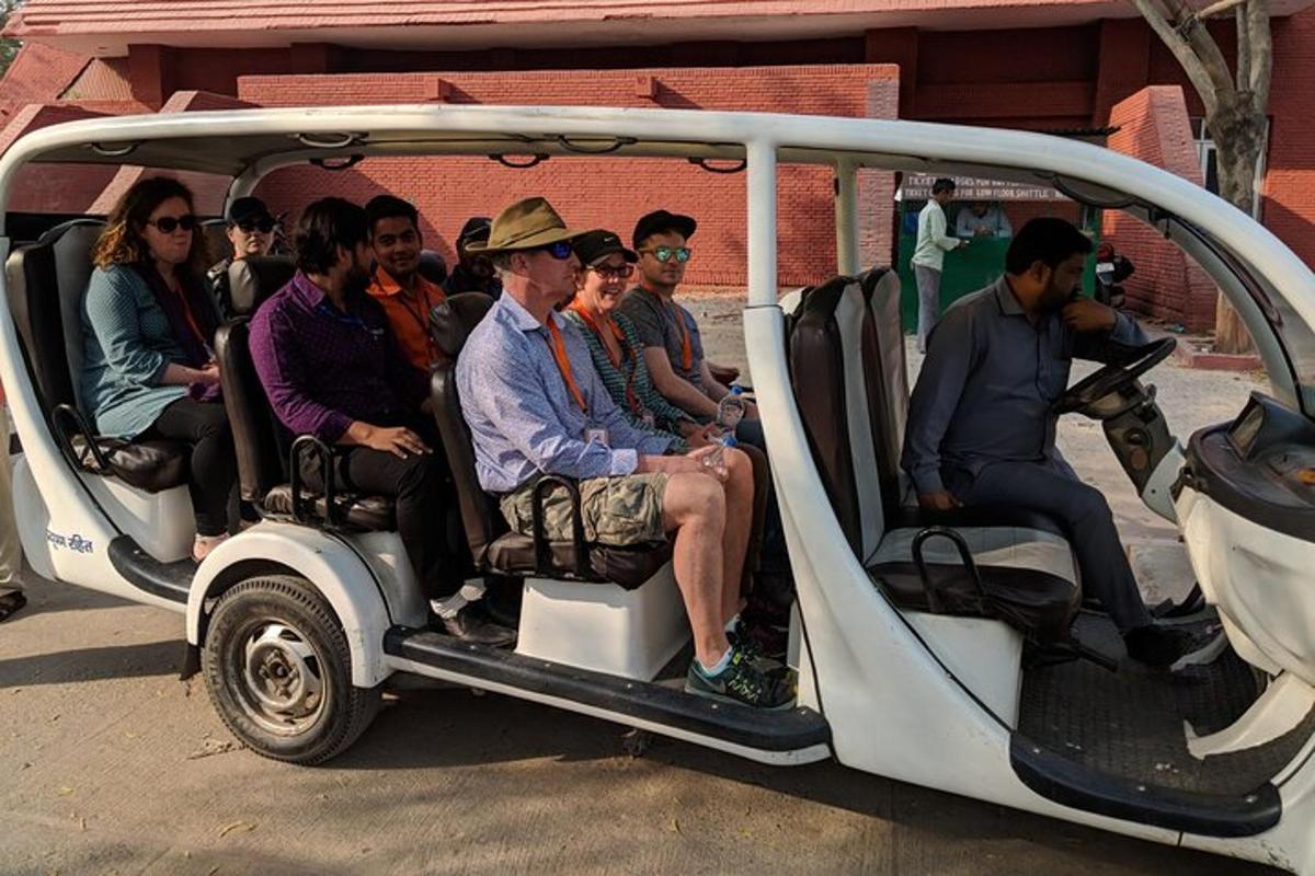 a group of people riding in a golf cart