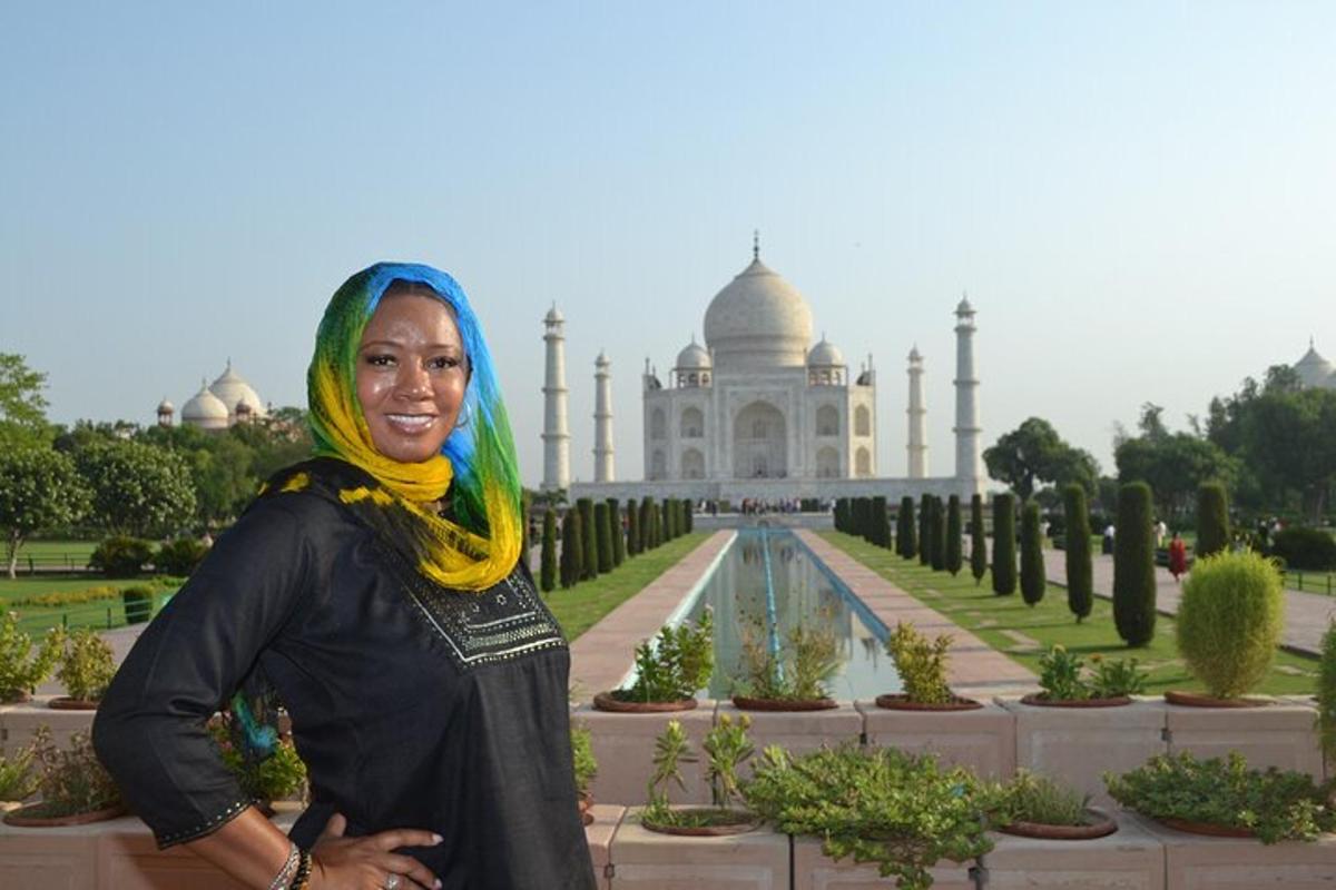 a woman with green hair standing in front of a building