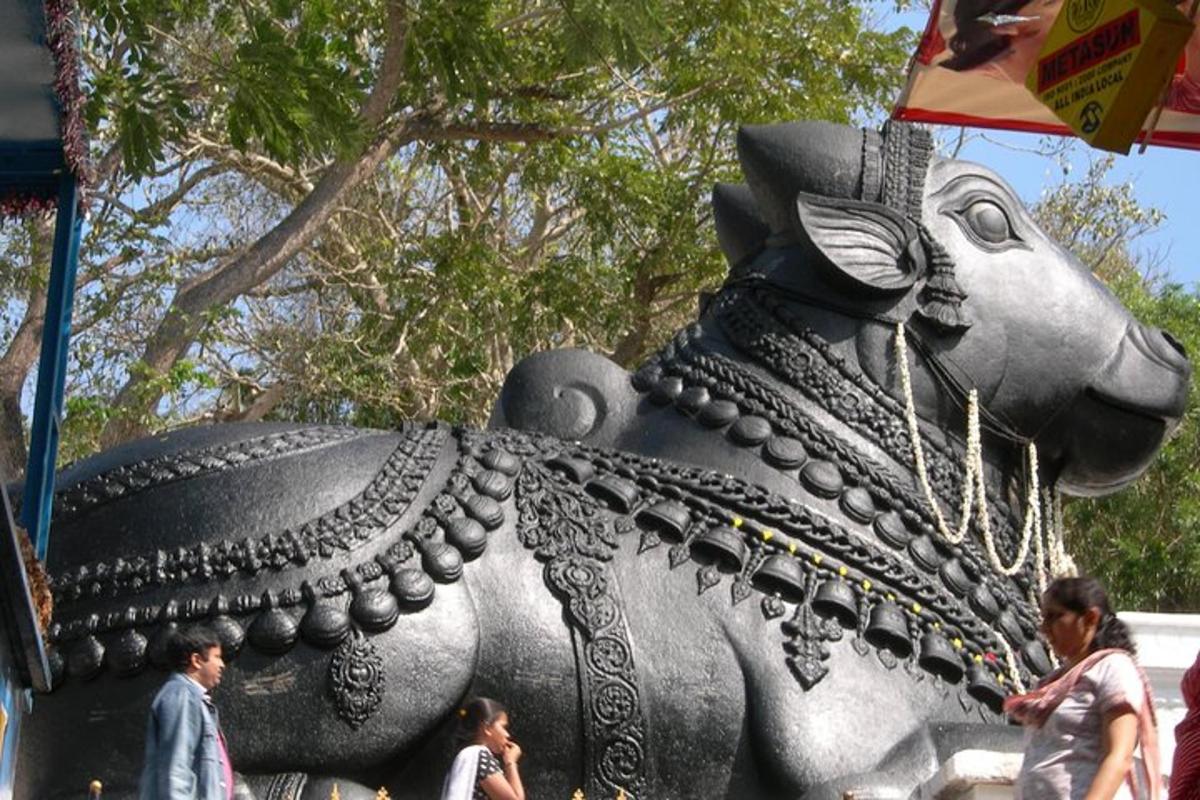 a large elephant statue with people walking around it