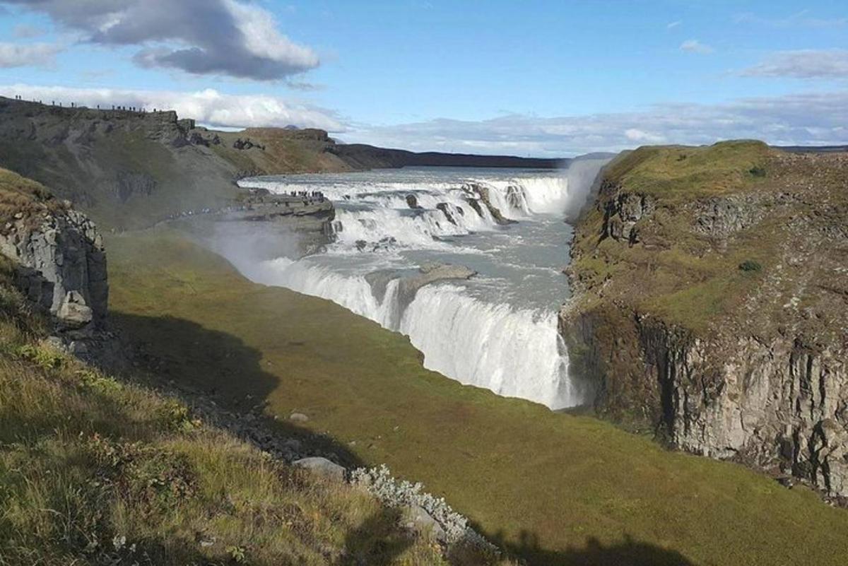 a waterfall on the side of a river