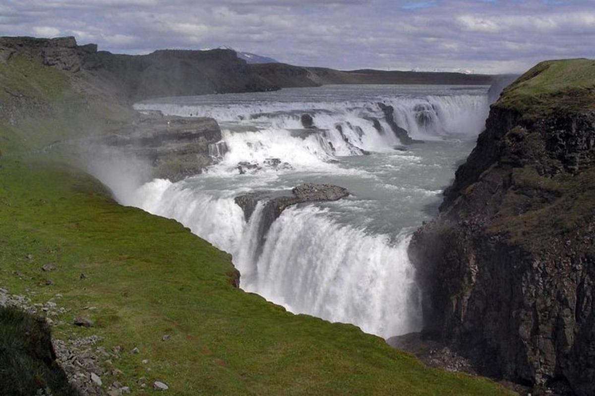 a waterfall on the side of a river