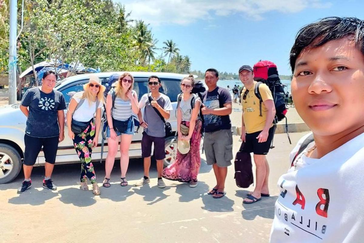 a group of people standing in front of a car