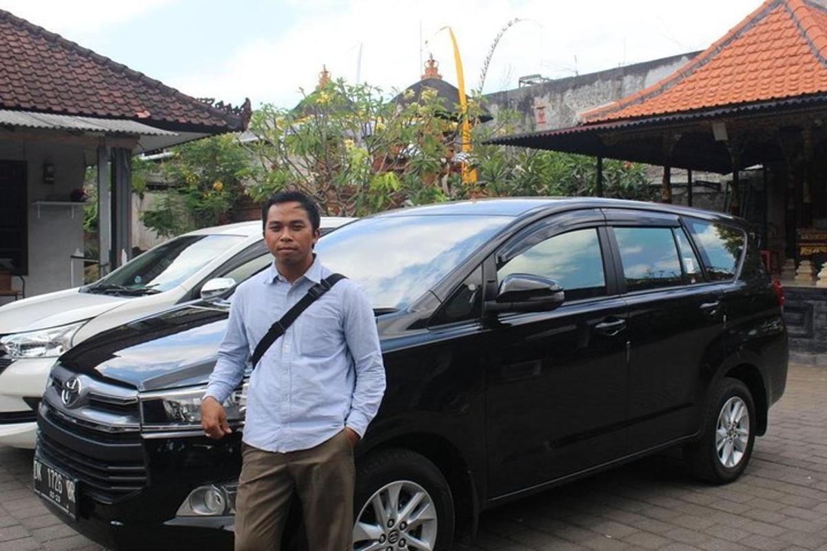 a man standing in front of a black car