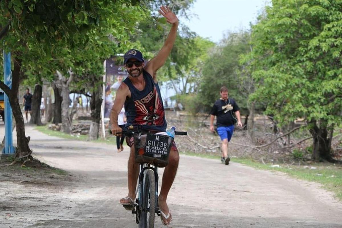 a man riding a bike with his hand in the air
