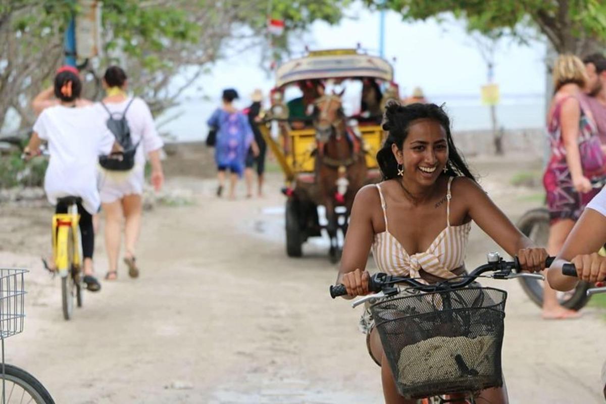 a woman riding a bike down a dirt road