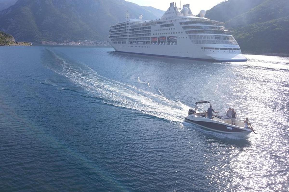 isang bangka sa tubig na may cruise ship