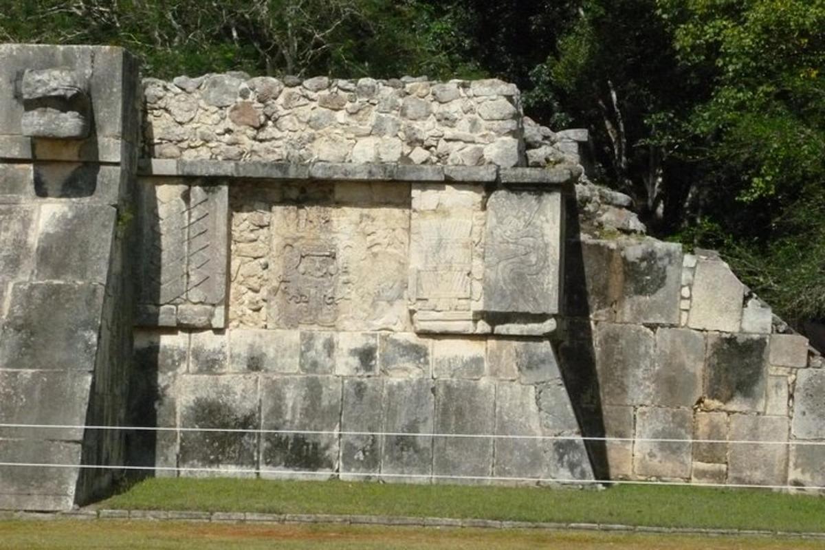 a stone wall with a fence in front of it