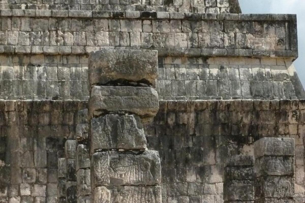 a stone statue on the side of a building