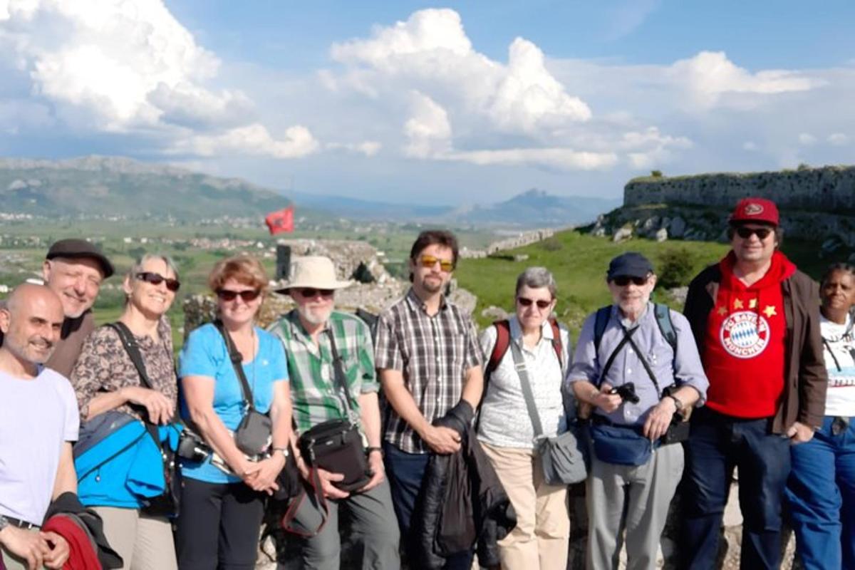a group of people standing on the top of a mountain