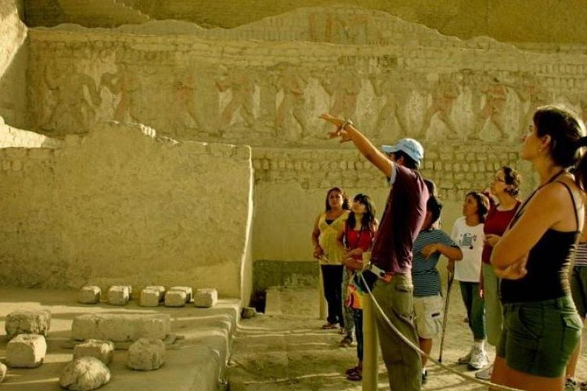 a group of people standing in front of a stone wall