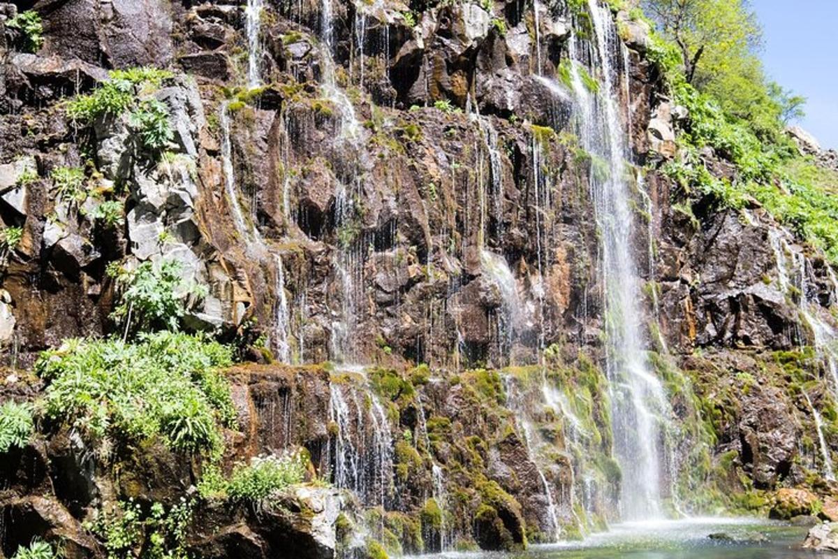 a waterfall on the side of a mountain
