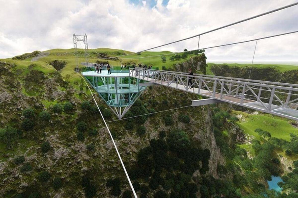 a suspension bridge over a mountain with people on it