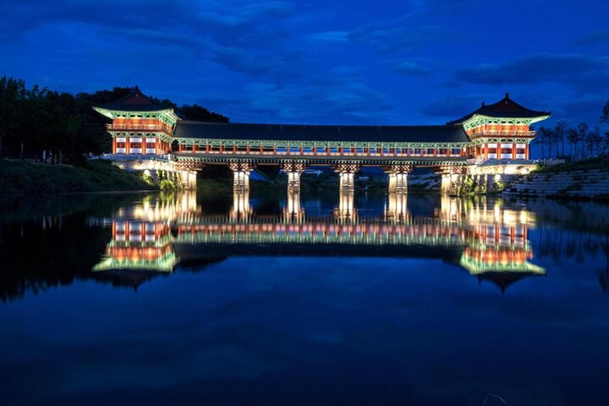 a japanese building on the water at night