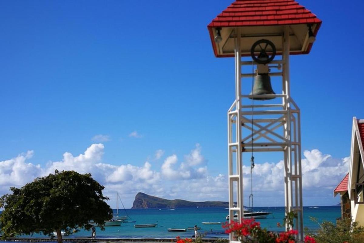 sebuah menara loceng dengan bumbung merah di hadapan lautan