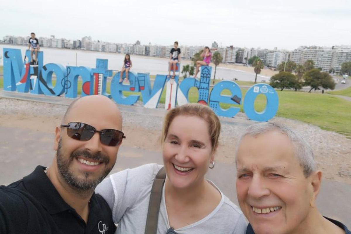 two men and a woman standing in front of a park