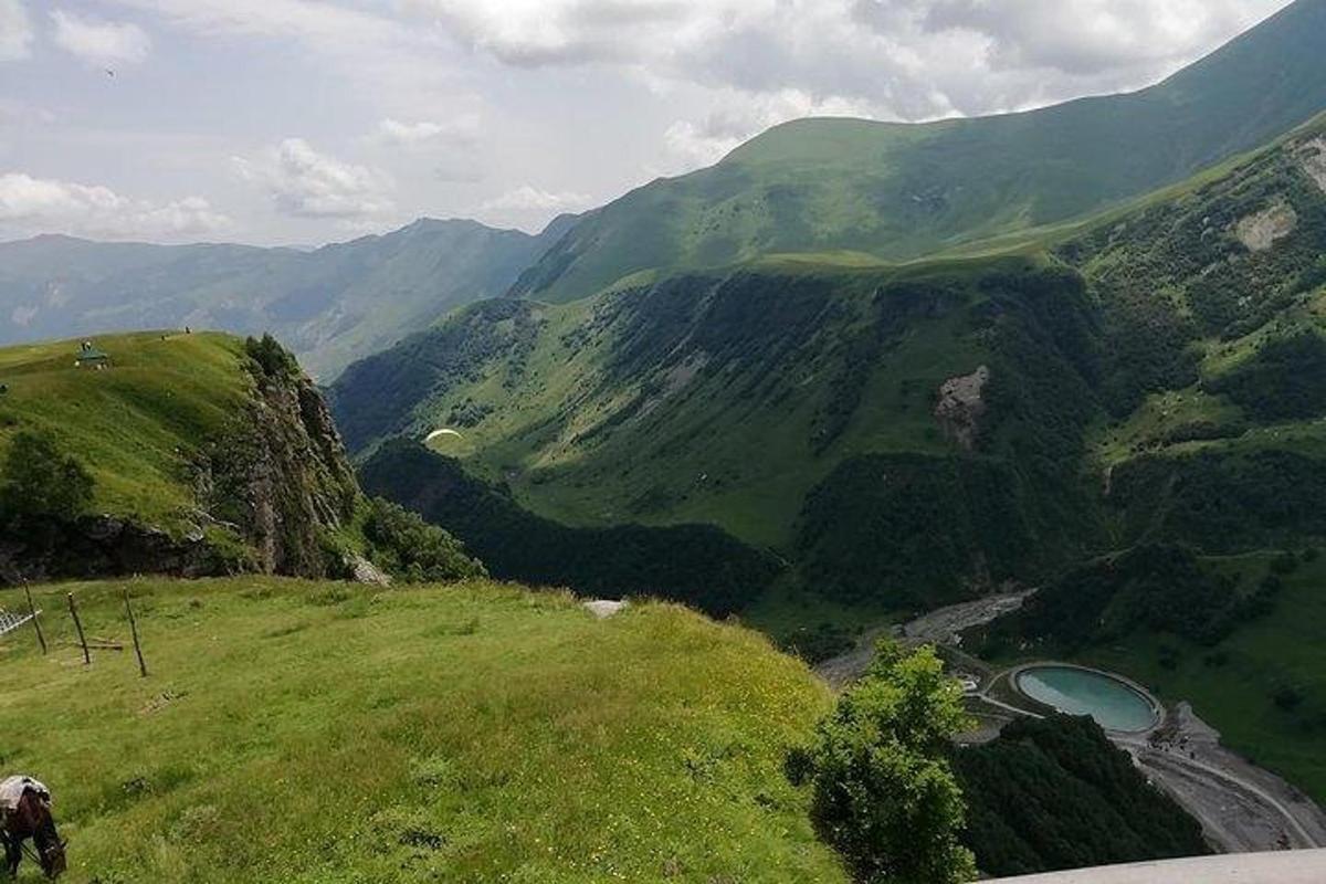 a view of a mountain with a river in a valley