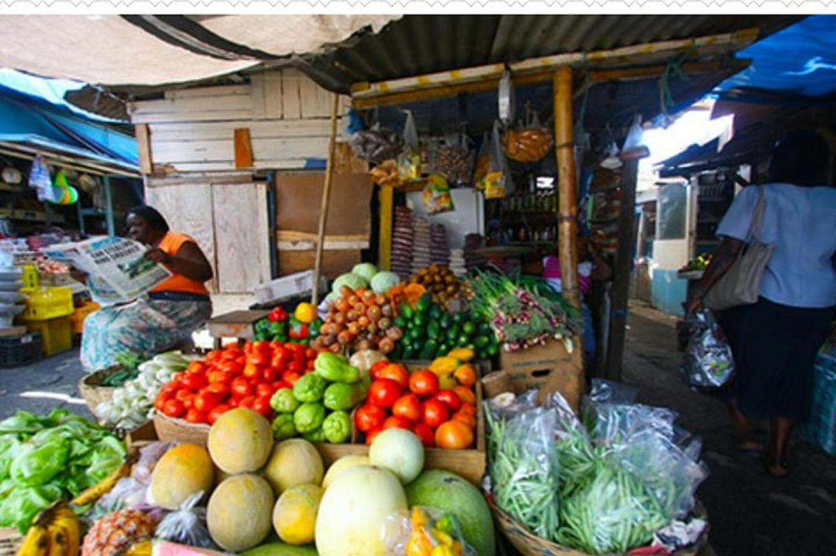 a market with a bunch of fruits and vegetables on display