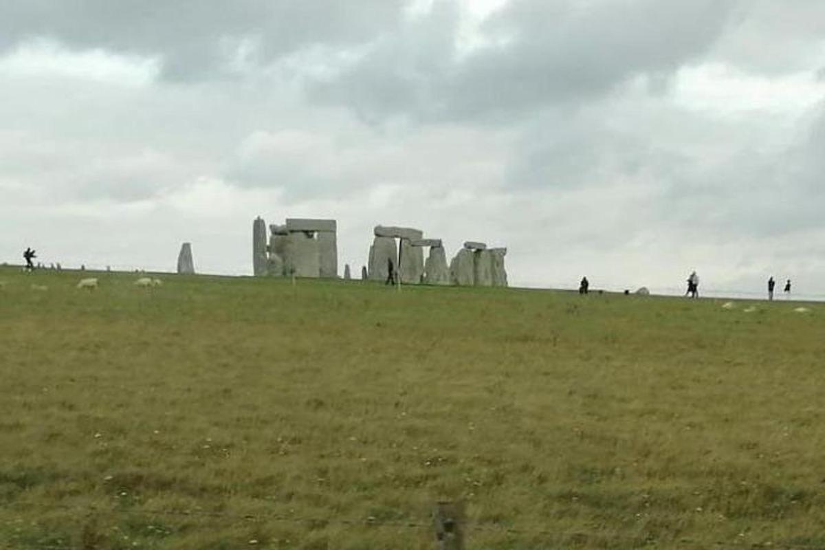 grupp inimesi seisab väljal, kus asub Stonehenge