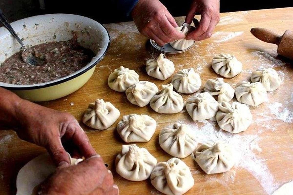 o persoană care pregătește mâncarea pe o placă de tăiat lemn