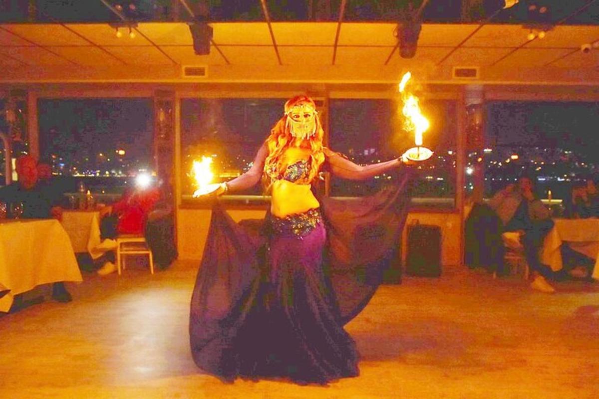 a woman in a dress holding torches in a room