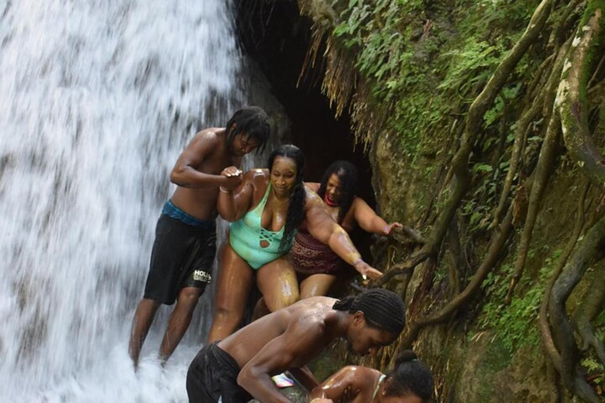 sekumpulan orang berdiri di hadapan air terjun