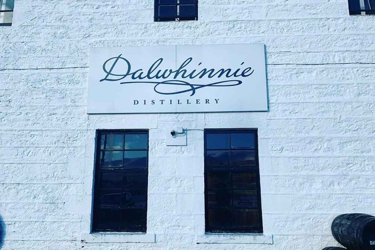a sign on the side of a white brick building