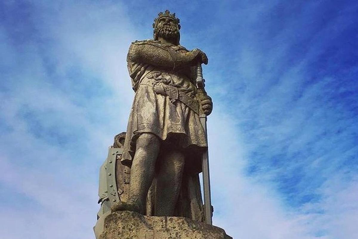 una statua di un uomo in piedi in cima a un monumento