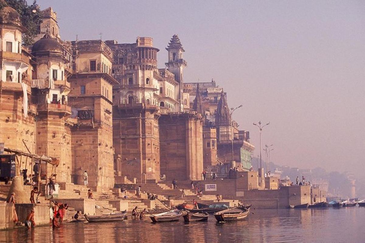a large building next to a body of water with boats