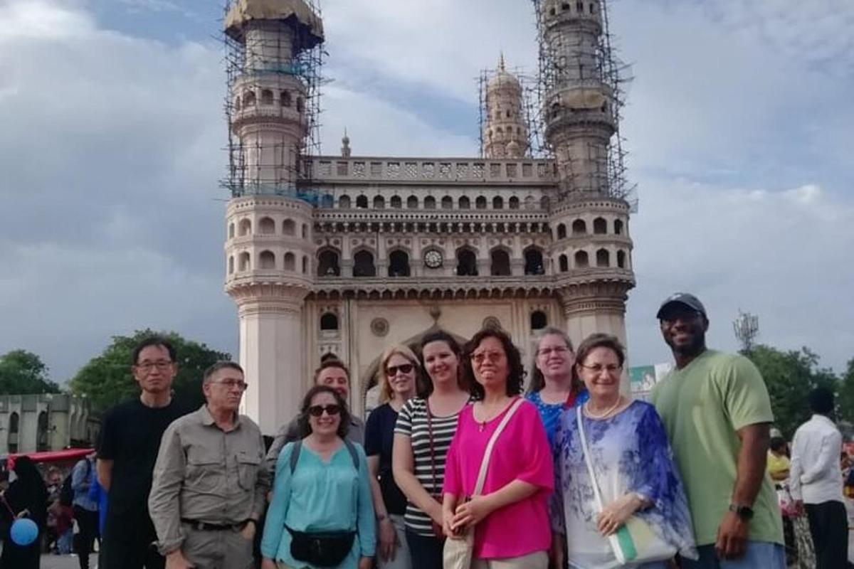 a group of people standing in front of the leaning tower
