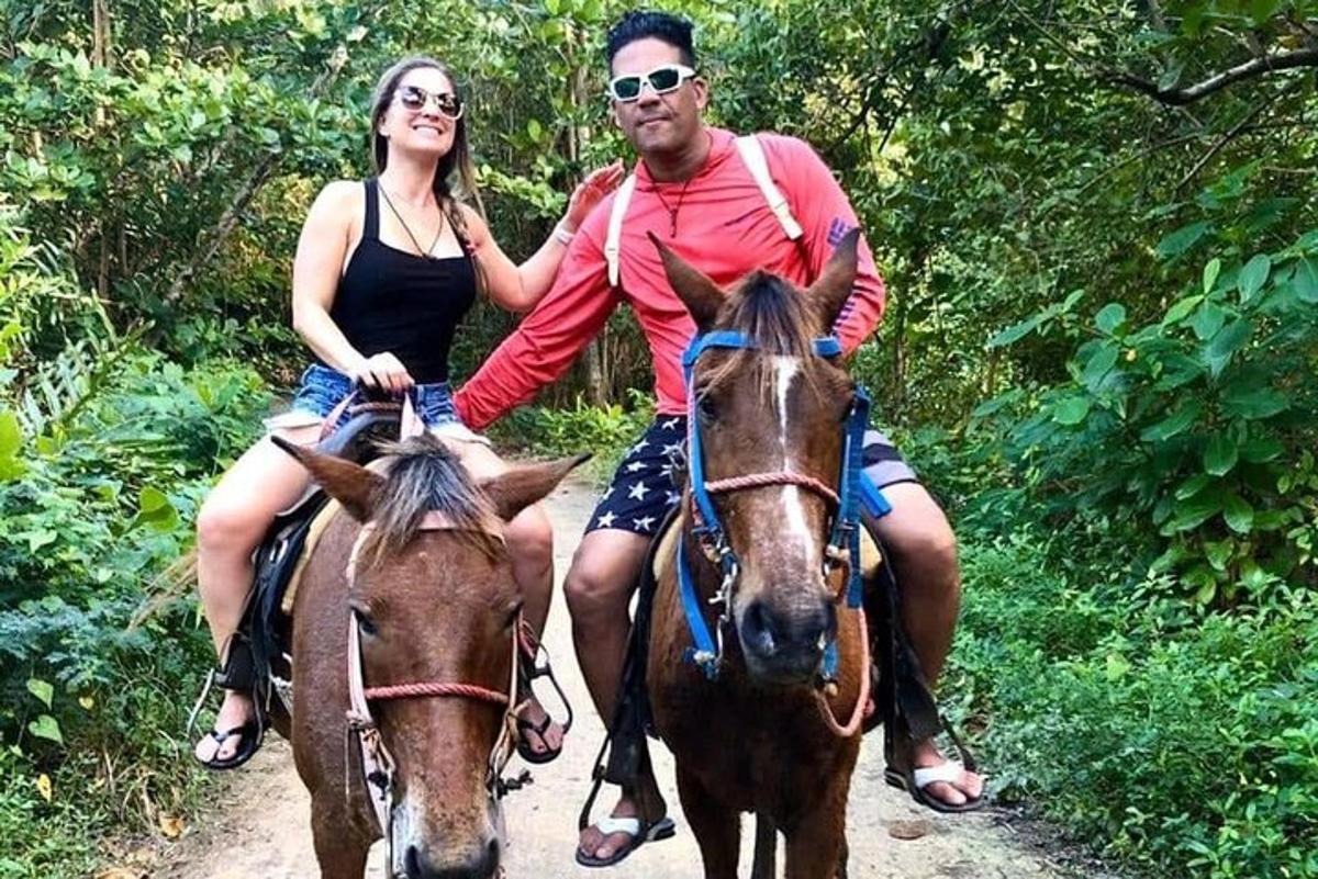 a man and a woman riding horses on a trail