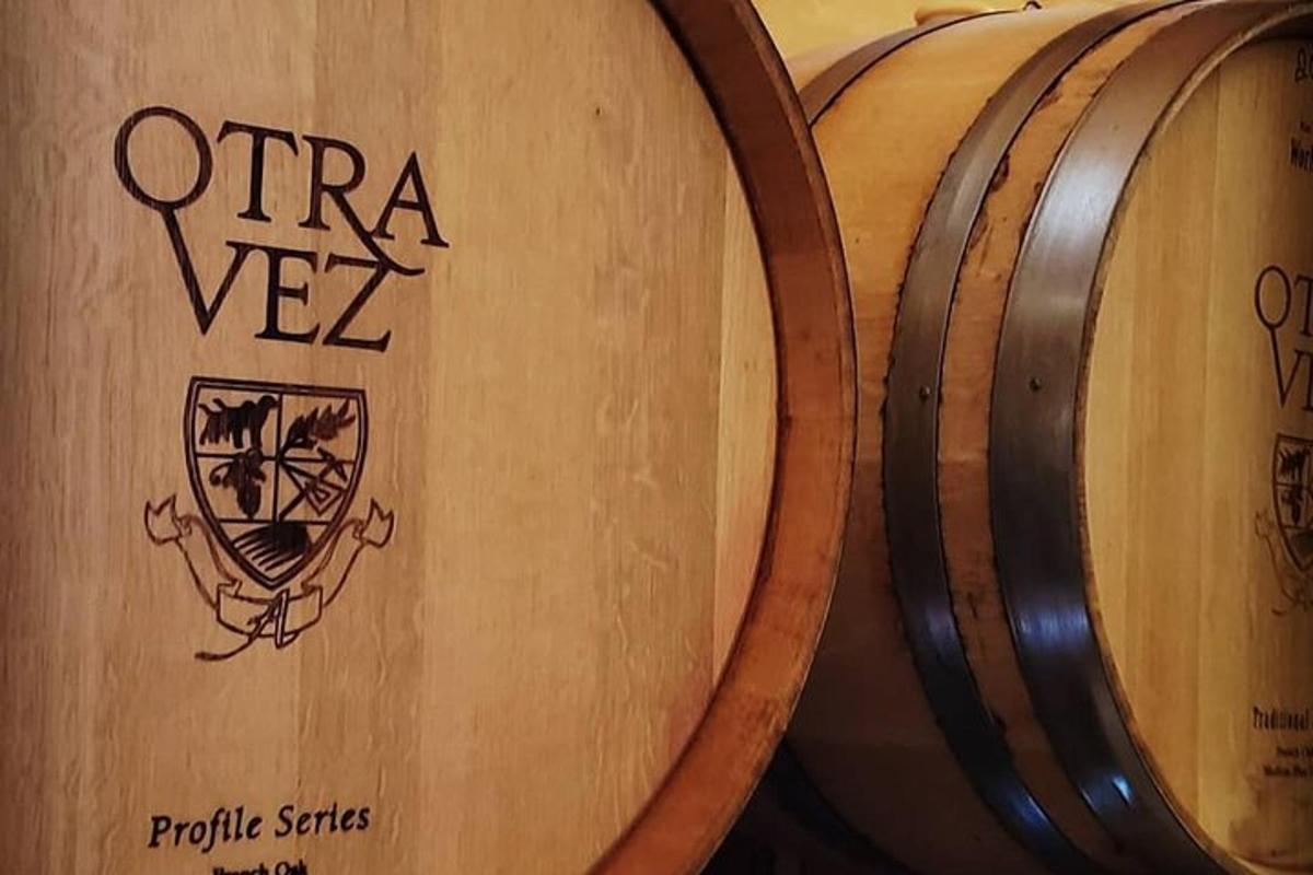 a pair of wooden wine barrels next to each other