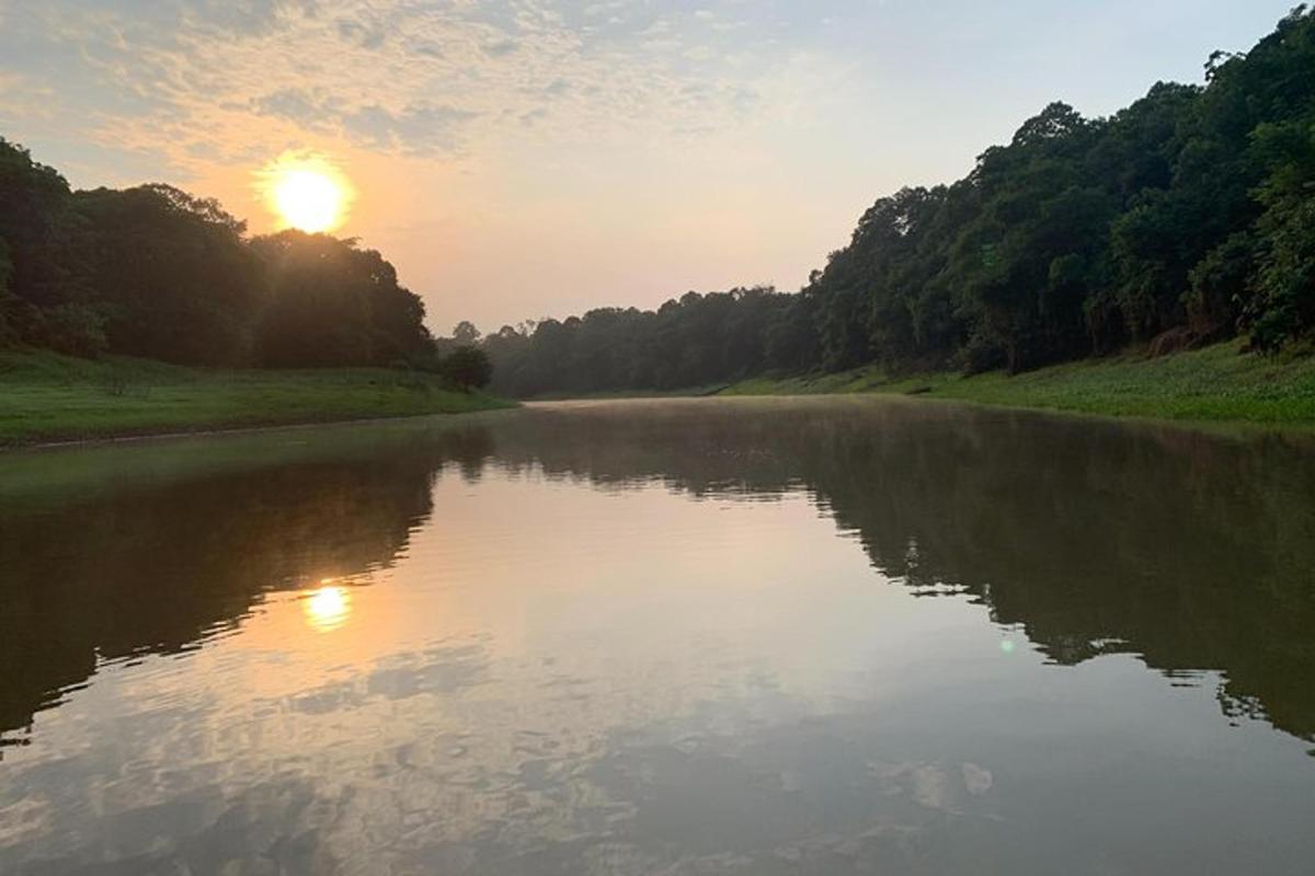a river with the sun setting in the distance