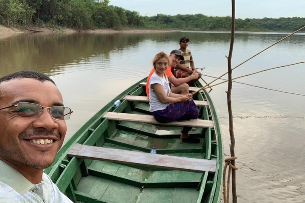 a group of people sitting in a boat on the water