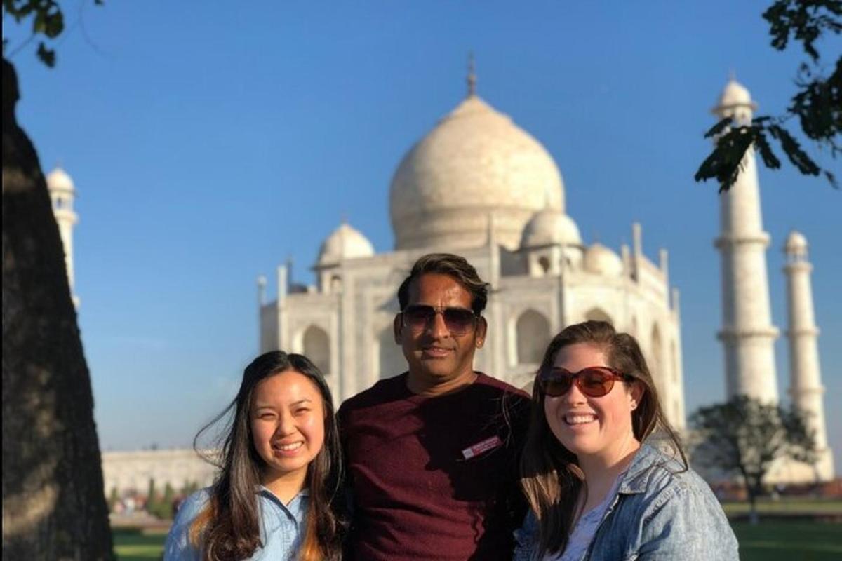 a man and two women standing in front of a building