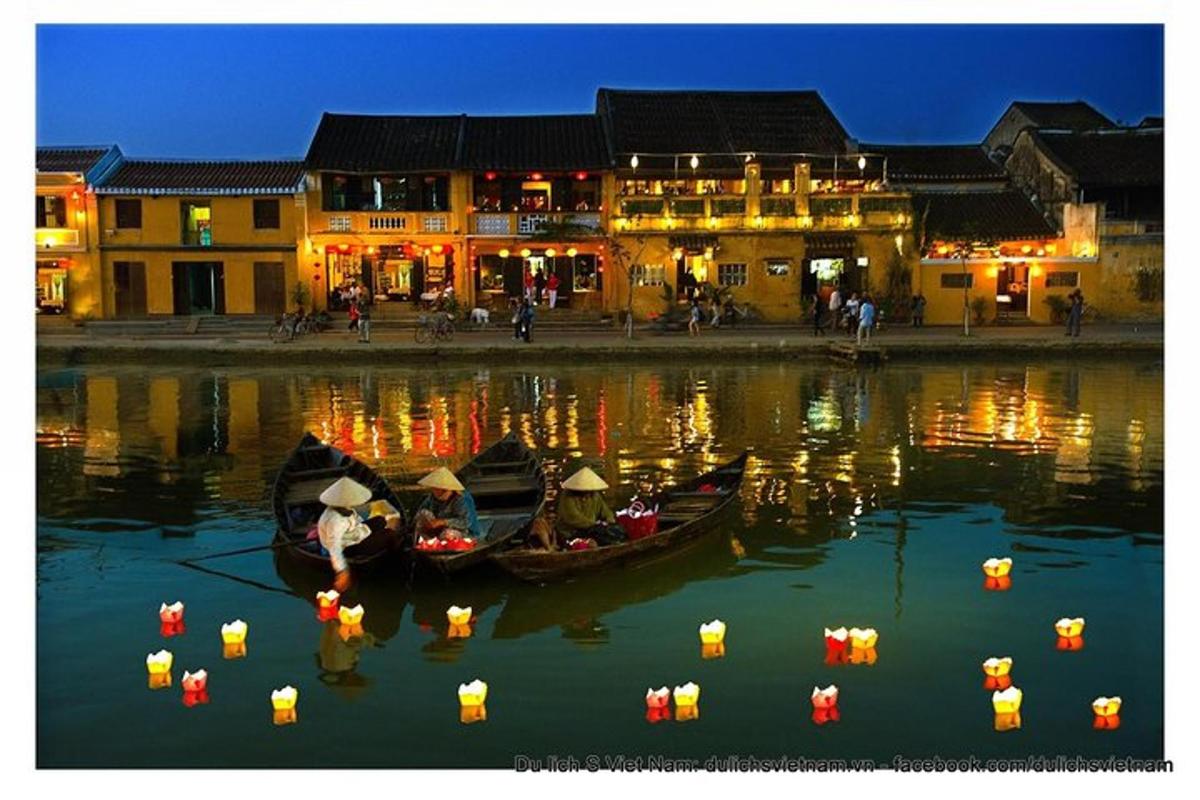two boats in the water in front of buildings