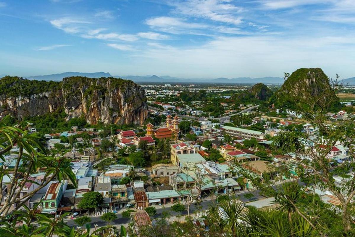 an aerial view of a city with mountains and trees