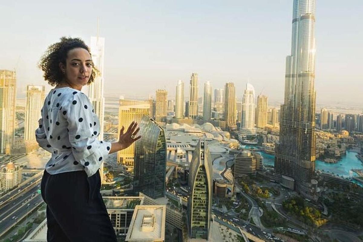 a woman standing on top of a skyscraper